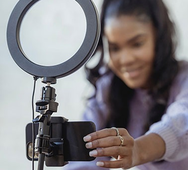 Woman Setting Up Phone With Ring Light