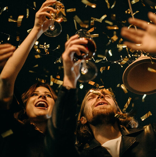 Group Of People Celebrating Amid Colorful Confetti