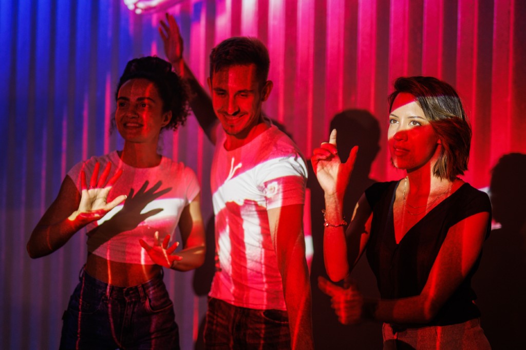 Group Of People Enjoying Colorful Lights